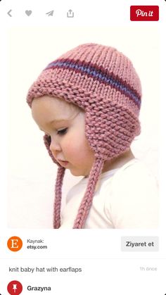 a small child wearing a pink knitted hat