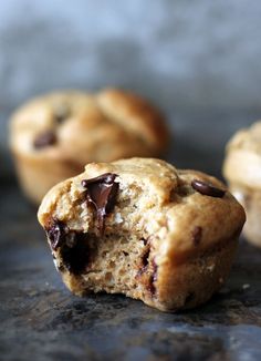 two chocolate chip muffins sitting on top of a counter