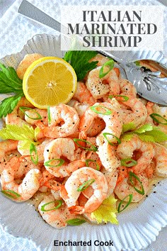 a white plate topped with shrimp next to a lemon wedge