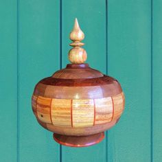 a wooden object hanging from the side of a blue wall