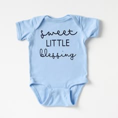 The perfect bodysuit for your perfect baby! These short sleeve bodysuits have 3 snap closure and double needle ribbed binding on neck, shoulders, sleeves, and leg openings. Machine wash cold, inside out. Air dry or tumble dry low. Cute Cotton Onesie For Baptism, Cute Light Blue Onesie For Playtime, Cute Blue Short Sleeve Onesie, Blue Cotton Bodysuit With Letter Print, Fitted Blue Onesie With Letter Print, Blue Short Sleeve Onesie With Letter Print, Baby Boy Onesies Ideas, Baby Onsies Ideas, Baby Onesie Ideas