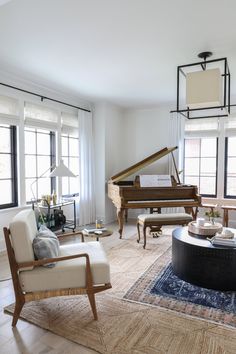 a living room filled with furniture and a grand piano