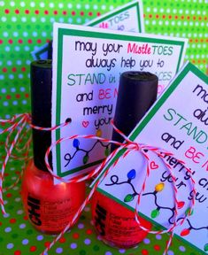 three red nail polish bottles are tied up with twine and two cards that say, may your master toes always help you to stand up and be merry