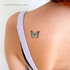 a woman's back with a small butterfly tattoo on her left side ribcage