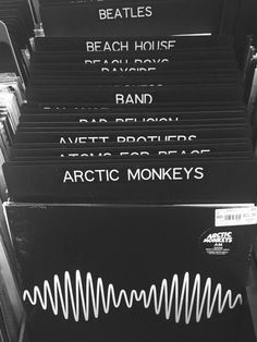 a bunch of black and white records are stacked on top of each other with the words arctic monkeys above them