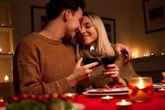 a man and woman sharing a glass of wine