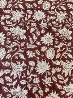 the fabric is brown and white with flowers on it