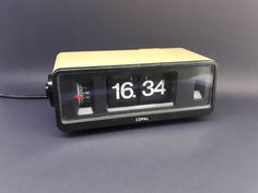 an alarm clock sitting on top of a table