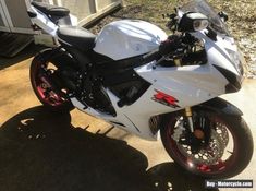 a white and black motorcycle parked in front of a building