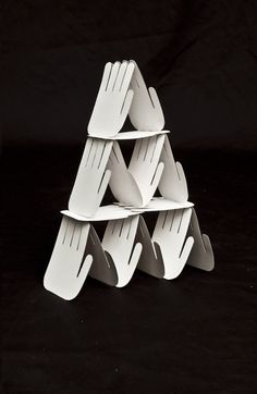 a stack of white plastic utensils sitting on top of a black table next to each other