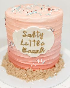 there is a pink and red cake with gold writing on the top that says salty little beaky