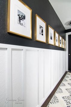 a hallway with pictures on the wall and carpet