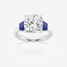 a diamond and blue sapphire engagement ring on a white background with the center stone set in 18k white gold