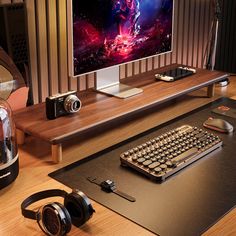 a desk with headphones and a computer monitor on it, along with other electronics