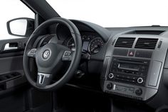 the interior of a car with dashboard controls and steering wheel