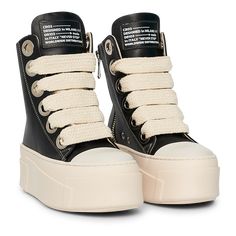 The sneakers are high-top platform-style shoes with a dominant color scheme of black and cream. They feature a thick, cream-colored rubber sole with layered detailing that gives the shoe a bold and chunky silhouette. The upper part of the sneakers is primarily black, constructed with leather material. The design includes metal eyelets for the laces, which are cream-colored and chunky, complementing the sole. Wishlist Shoes, High Top Tennis Shoes, High Platform Shoes, Chunky Platform Sneakers, Men Boot, Pretty Shoes Sneakers, All Nike Shoes, Cute Sneakers, Lace Sneakers