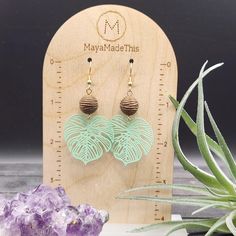 These monstera leaf earrings feature light green painted brass monstera leaf pendants measuring 34mm x 32mm dangling from 12mm brown acrylic beads with an interesting rope texture! The ear wires are made of hypoallergenic gold-plated surgical steel, making these earrings safe for sensitive ears! They measure approximately 2.5 inches from the top of the ear wires to the bottom of the pendant, and are very lightweight, weighing just 0.1 ounce each! Domestic shipping is always free here at Mayamade Green Leaf-shaped Earrings For Pierced Ears, Green Leaf-shaped Earrings, Green Leaf-shaped Jewelry With Matching Earrings, Handmade Green Leaf-shaped Earrings, Handmade Adjustable Leaf-shaped Earrings, Handmade Green Leaf-shaped Jewelry, Nickel-free Green Leaf-shaped Jewelry, Nature-inspired Green Jewelry With Ear Wire, Green Hypoallergenic Nature-inspired Jewelry