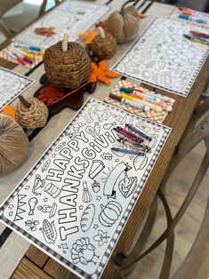 the table is set up with pumpkins and coloring pages on it for kids to color