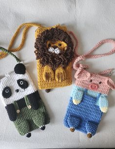 three crocheted cell phone cases with animals on them, one in the shape of a bag