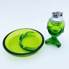 a green glass plate next to a green glass vase