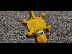 a yellow stuffed animal laying on top of a carpet