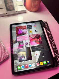 an ipad sitting on top of a pink table