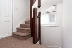 the stairs in this house are made of wood and carpet