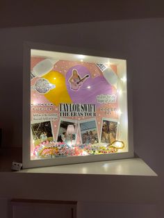 a display case with an assortment of items on it's sides and lights in the background