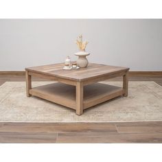 a wooden coffee table sitting on top of a rug