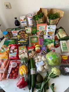 a table topped with lots of different types of vegetables and food items next to each other