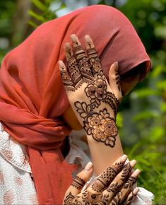 a woman with henna on her head and hands