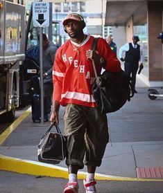 a man walking down the street carrying a bag