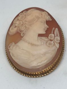 Vintage cameo brooch with moveable loop to use as a pendant. Cameo mounted in yellow gold Mark unreadable  High gold content Cameo is signed  Total weight 13g Measures 45mm x 34mm Antique Cameo Medallion Brooch, Victorian Cameo Brooches In Yellow Gold, Victorian Cameo Brooch In Yellow Gold, Antique Cameo Medallion Brooches, Victorian Yellow Gold Cameo Brooches, Antique Gold Cameo Brooch, Antique Gold Cameo Brooches, Antique Oval Cameo Brooch, Formal Cameo Pendant Brooch