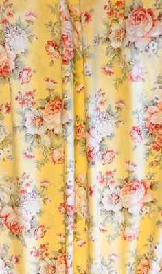 a yellow floral curtain with pink flowers on it