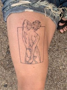 a person with a tattoo on their leg that has a drawing of a naked man