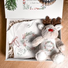 a baby's first christmas gift box with a teddy bear and t - shirt