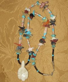 "An Original 1970's Running Bear Shop Signed Boulder Ribbon Turquoise & Sterling Necklace. Visit this shop for a wide variety of Vintage Quality Jewelry, Art, Photos and Collectibles. ~Age (approximate): 1970's ~Material(s): Turquoise & Sterling ~Approx. Size: necklace measures 15\" long & Pendant measures 2 1/4\" long ~Approx. Weight: N/A ~Signature / Brand: Signed. There is a pendant on the clasp that is marked R. B. (Inside A Bear) Sterling. ~Condition: Excellent. Clasp A Bit Tarn Collectible Turquoise Necklace With Natural Stones, Handmade Southwestern Style Collectible Necklaces, Turquoise Spiritual Necklace With Inlay, Spiritual Turquoise Inlay Necklace, Spiritual Turquoise Necklace With Inlay, Vintage Multicolor Turquoise Necklace With Natural Stones, Spiritual Turquoise Necklace Collectible, Running Bear, Sterling Necklace