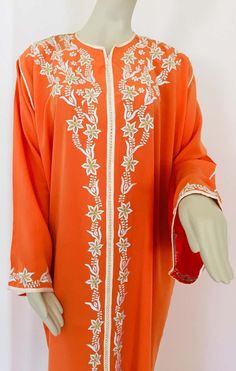 For Sale on 1stDibs - Elegant Moroccan caftan orange color embroidered with gold trim, circa 1970s. This long maxi dress kaftan trim is embroidered and embellished with pearls Spring Bollywood Kaftan With Dabka Work, Bollywood Style Spring Kaftan With Dabka Work, Bollywood Style Dabka Work Kaftan For Spring, Spring Wedding Kaftan With Dabka Work, Hand Embellished Long Sleeve Kaftan For Eid, Spring Traditional Kaftan With Dabka Work, Traditional Dabka Work Kaftan For Spring, Summer Long Sleeve Kaftan With Dabka Work, Orange Long Sleeve Dress For Eid