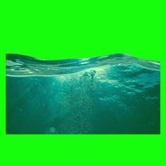 an underwater view of the ocean with sunlight shining on the water and bubbles coming out of it