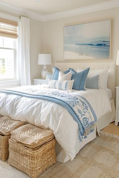 a white bed with blue and white decor in a bedroom