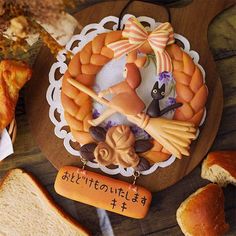 an assortment of breads and pastries on a wooden board with writing in japanese