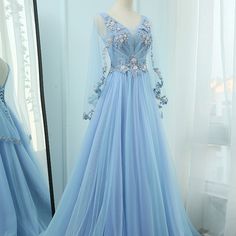 Light Blue Prom Dress Sleeves, Light Blue Wedding Dress Long Sleeve, Dresses With Capes Formal, Prom Dresses Plus Size With Sleeves, Blue Floral Dress Formal, Light Blue Gowns Elegant, Prom Dresses Blue Light, Dress With Cape Gowns, Blue Gowns Elegant