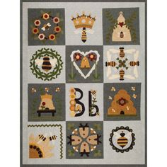 a quilted wall hanging with various designs and letters in the shape of animals, bees, hearts, wreaths