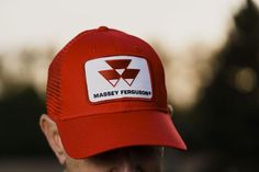 Hat with mesh back featuring the Massey Ferguson tractor logo. Emblem is sewn for durability. 6-panel structured hat. Red Six-panel Trucker Hat For Sports Events, Red Trucker Hat With Curved Brim And Logo Patch, Red Six-panel Trucker Hat For Sports, Red Breathable Trucker Hat, Red Six-panel Trucker Hat For Outdoor, Red 5-panel Trucker Hat For Sports, Tractor Logo, Ferguson Tractor, Allis Chalmers Tractors