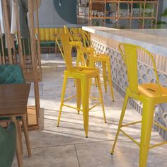 several yellow chairs are lined up against a wall in an outdoor area with tables and barstools