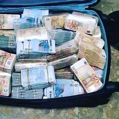 an open suitcase filled with lots of money