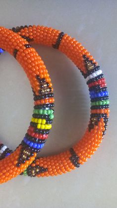 Beaded Bracelets | African Maasai Beaded Bracelets | African Jewelry | Zulu Beaded Bracelets | Ethnic Bracelets | Gift For Her | A Set Of Two These superbly crafted Zulu beaded bracelets are made of fine beads. The price is for a set of two bracelets. Main Color - Orange. Standard measurement is 7 - 8 inches. For smaller or bigger size please contact me. Available in different colors. Feel free to send me a convo or e-mail for any clarification. Thank you for visiting... Bohemian Orange Beaded Bangle Bracelets, Bohemian Orange Beaded Bangle Bracelet, Orange Bohemian Beaded Bangle Bracelet, Traditional Beaded Bangle Bracelets With Tiny Beads, Multicolor Round Beads Bangle For Festival, Traditional Beaded Bangle Bracelet With Tiny Beads, Bohemian Orange Beaded Bracelets With Round Beads, Traditional Tiny Beaded Bangle Bracelets, Bohemian Bangle With Colorful Beads