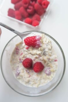 a bowl of oatmeal with raspberries on top