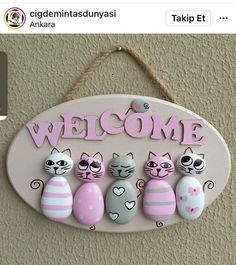 a sign that says welcome with three cats