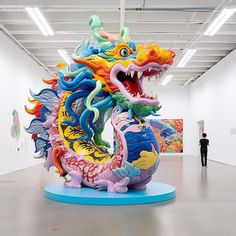 a large colorful dragon statue in an art gallery